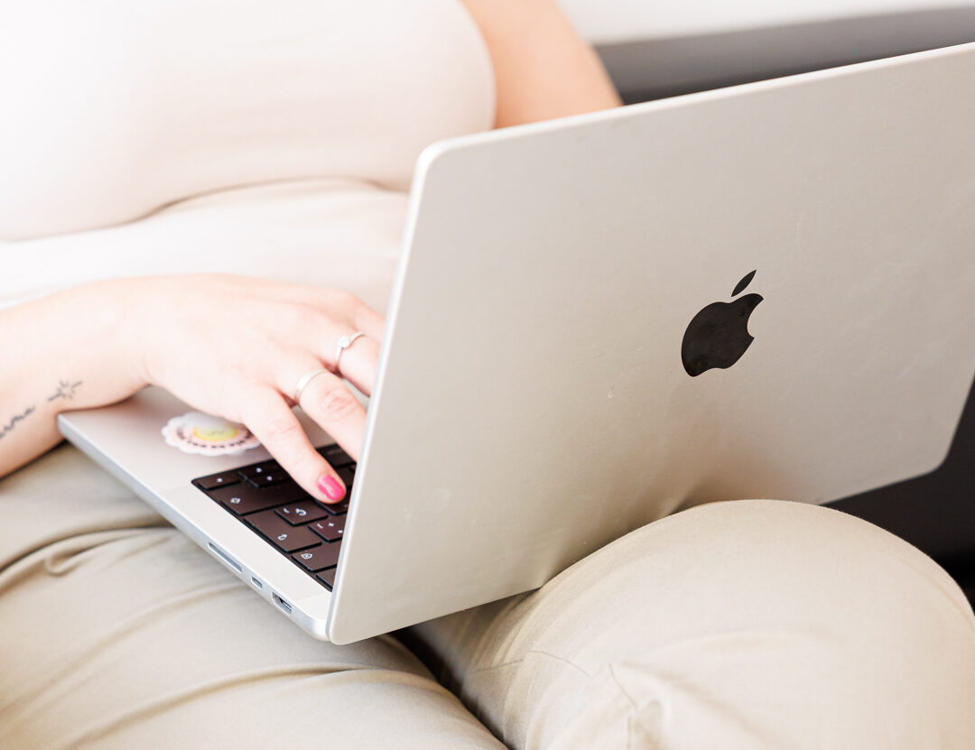 Hands typing on a computer